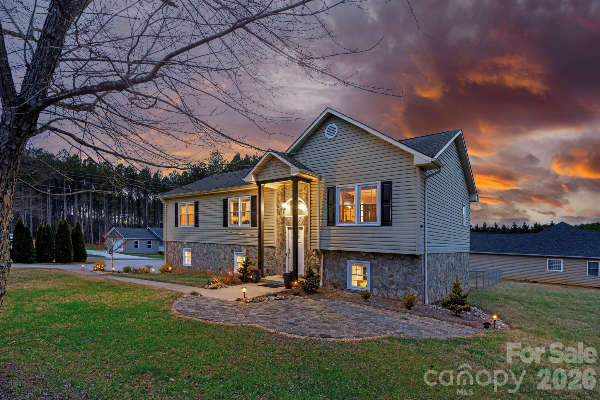 5750 Ellenwood Road Granite Falls, NC 28630 - Photo 2 of 38 a front view of a house with a yard and outdoor seating