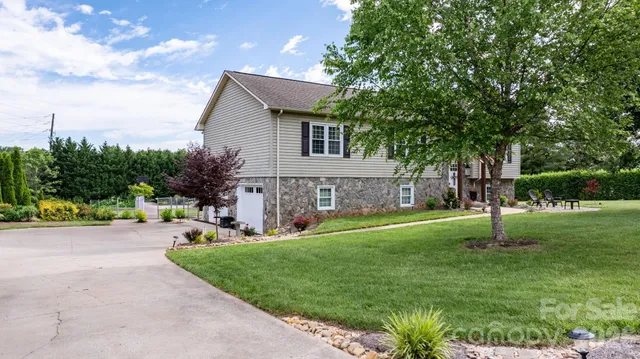 a view of a house with patio and a yard