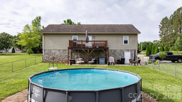 a view of a house with swimming pool and sitting area