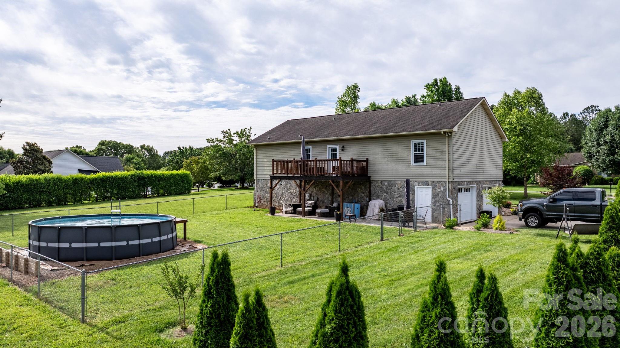 5750 Ellenwood Road Granite Falls, NC 28630 - Photo 31 of 38 a view of a house with backyard sitting area and garden