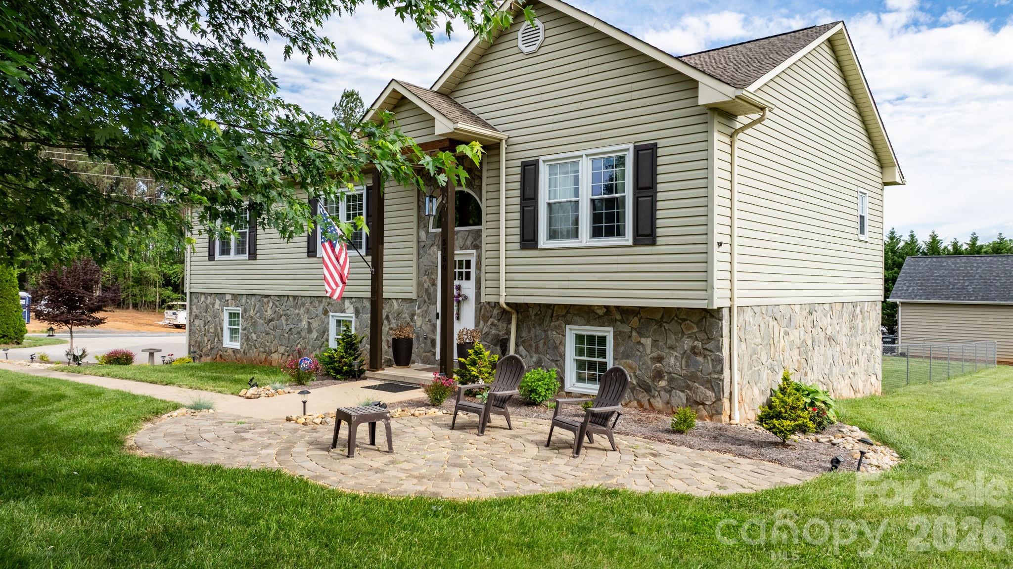 5750 Ellenwood Road Granite Falls, NC 28630 - Photo 32 of 38 a view of a house with patio and a yard