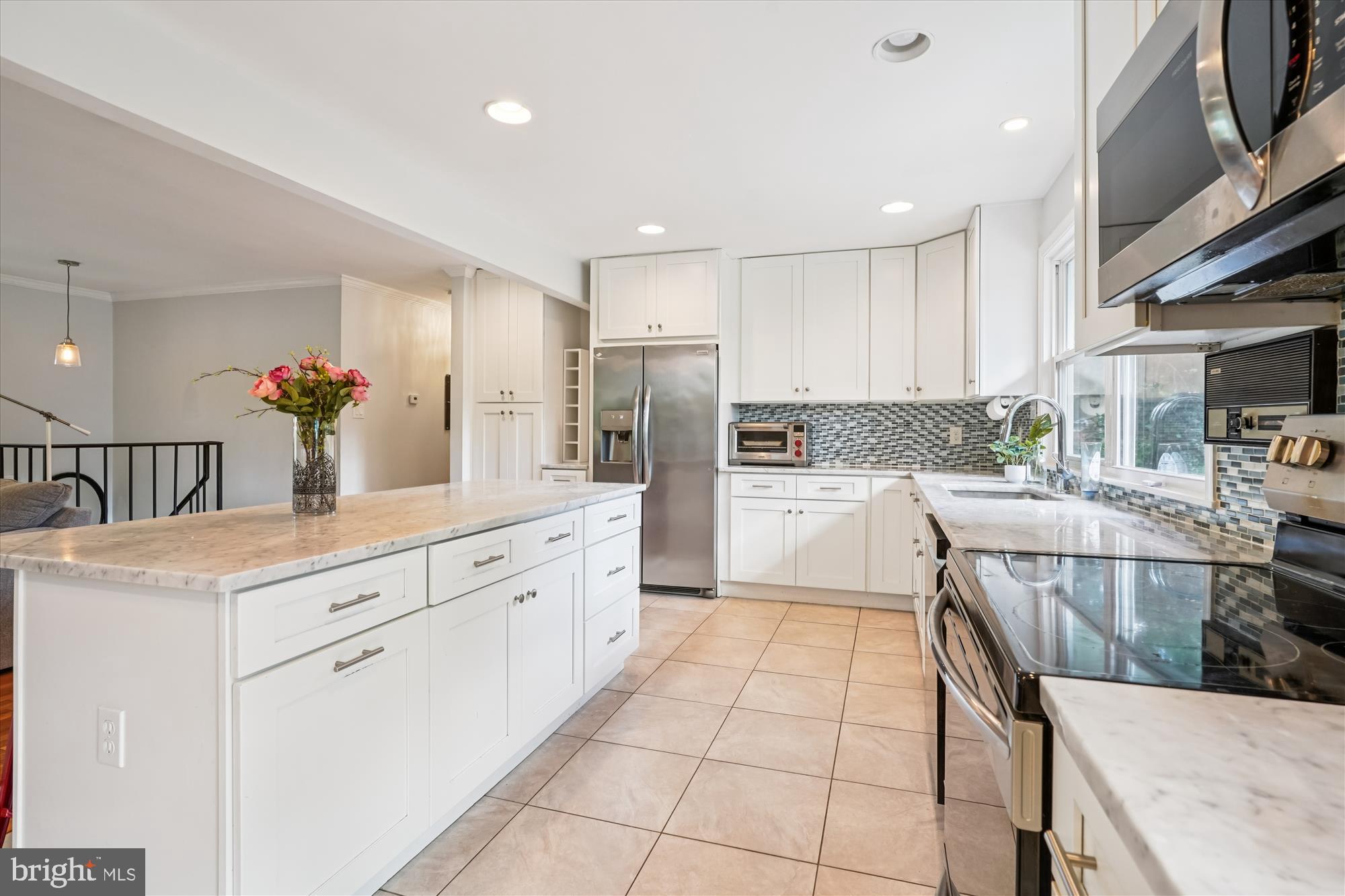 138 Courthouse Road Stafford, VA 22554 - Photo 2 of 29 a kitchen with stainless steel appliances kitchen island granite countertop a refrigerator and a sink
