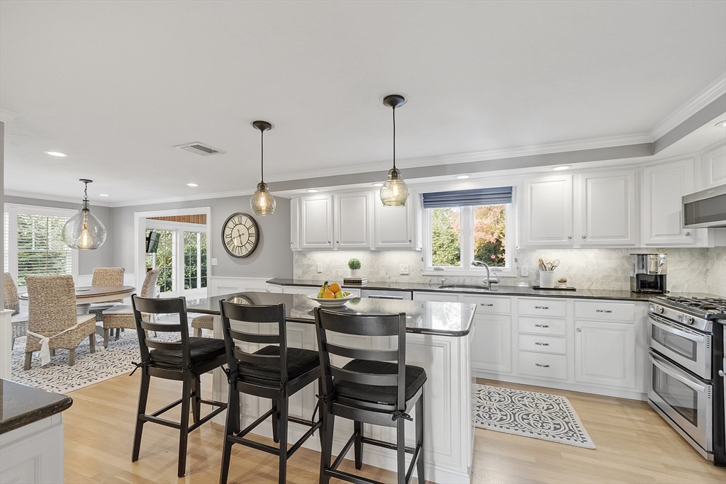 3 Baldwin Road Westford, MA 01886 - Photo 8 of 42 a open kitchen with granite countertop lots of white cabinets and stainless steel appliances