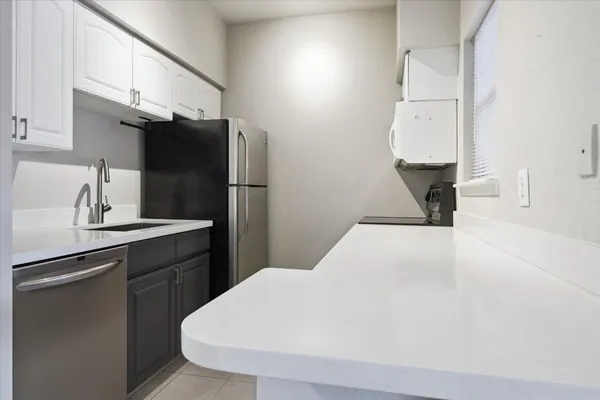 a kitchen with a sink and cabinets