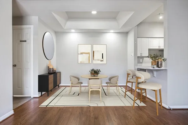 a living room with furniture a table and wooden floor