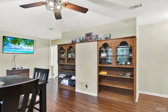 a view of a dining room with furniture and wooden floor