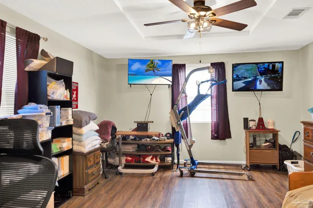 a living room with furniture gym equipment and a flat screen tv