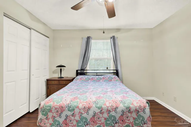 a bedroom with a bed and a wooden floor