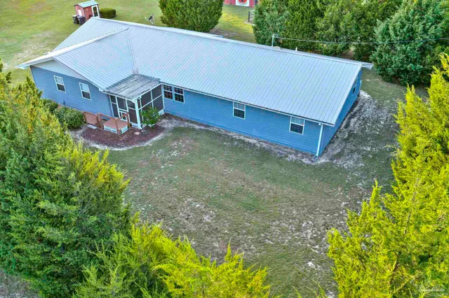 a view of a house with a yard and plants