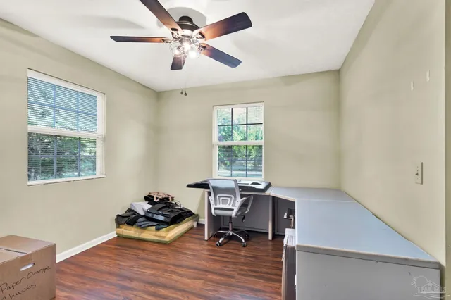 a workspace with wooden floor and a window
