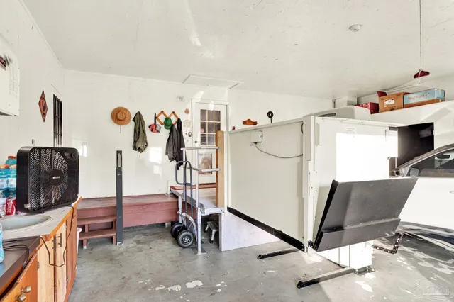 a view of a kitchen with fridge and workspace