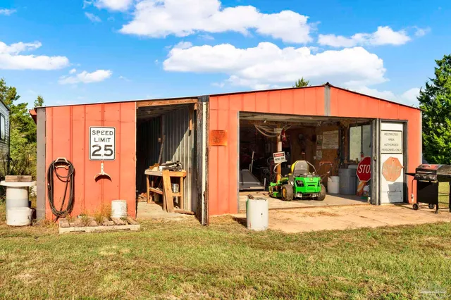a view of a patio with table and chairs under an umbrella