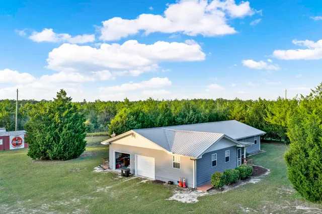 a backyard of a house with table and chairs