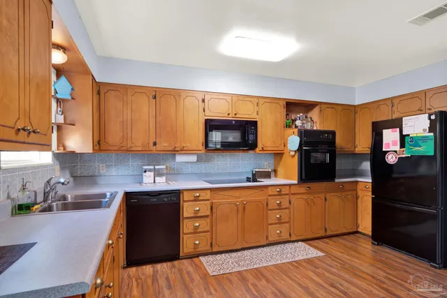 a kitchen with cabinets a sink and appliances