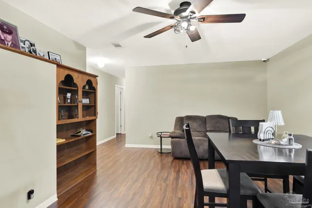 a view of a dining room with furniture and wooden floor