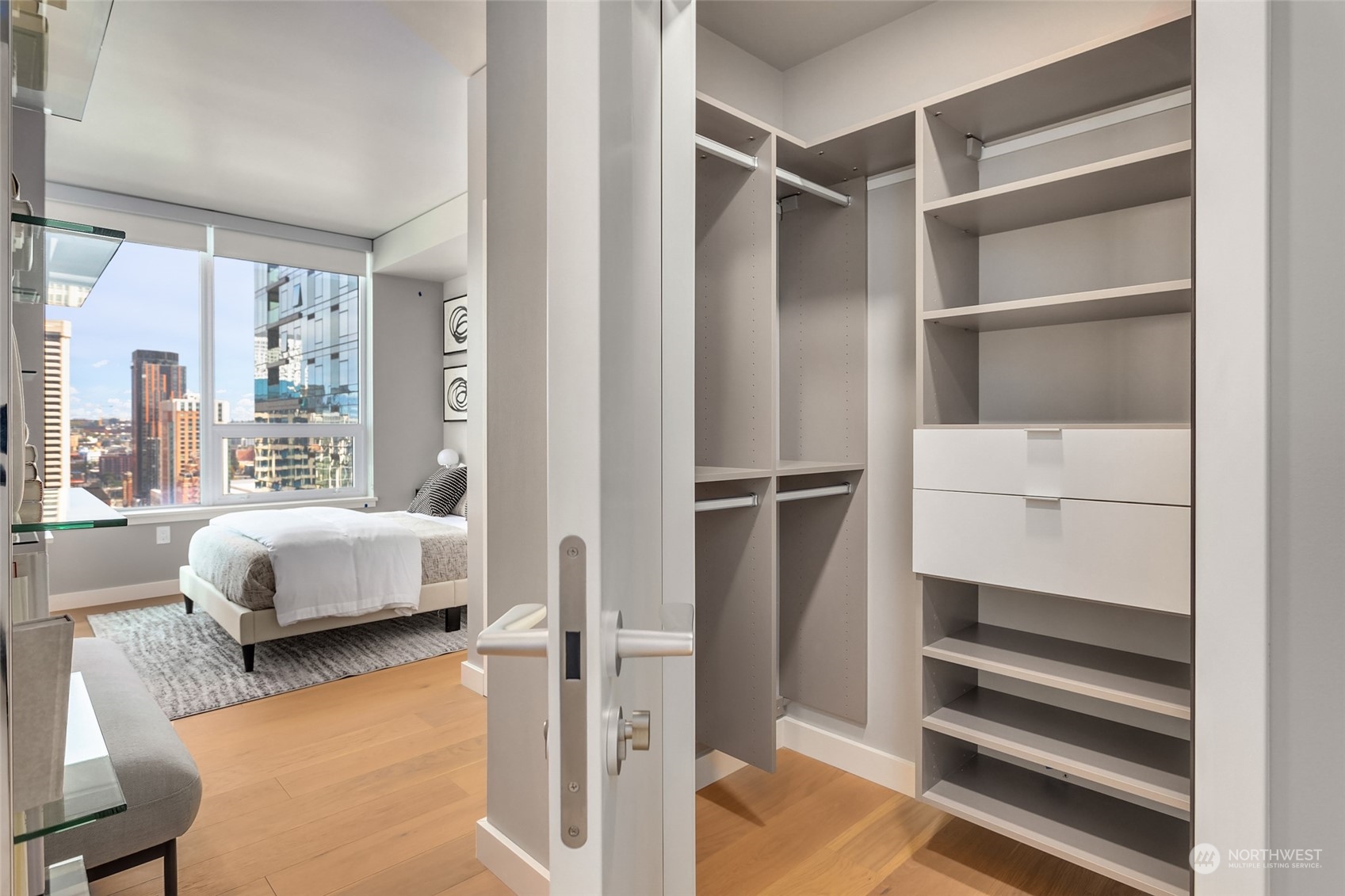 121 Stewart Street, Unit 1701 Seattle, WA 98101 - Photo 13 of 15 a bedroom with a bed and a window with chair