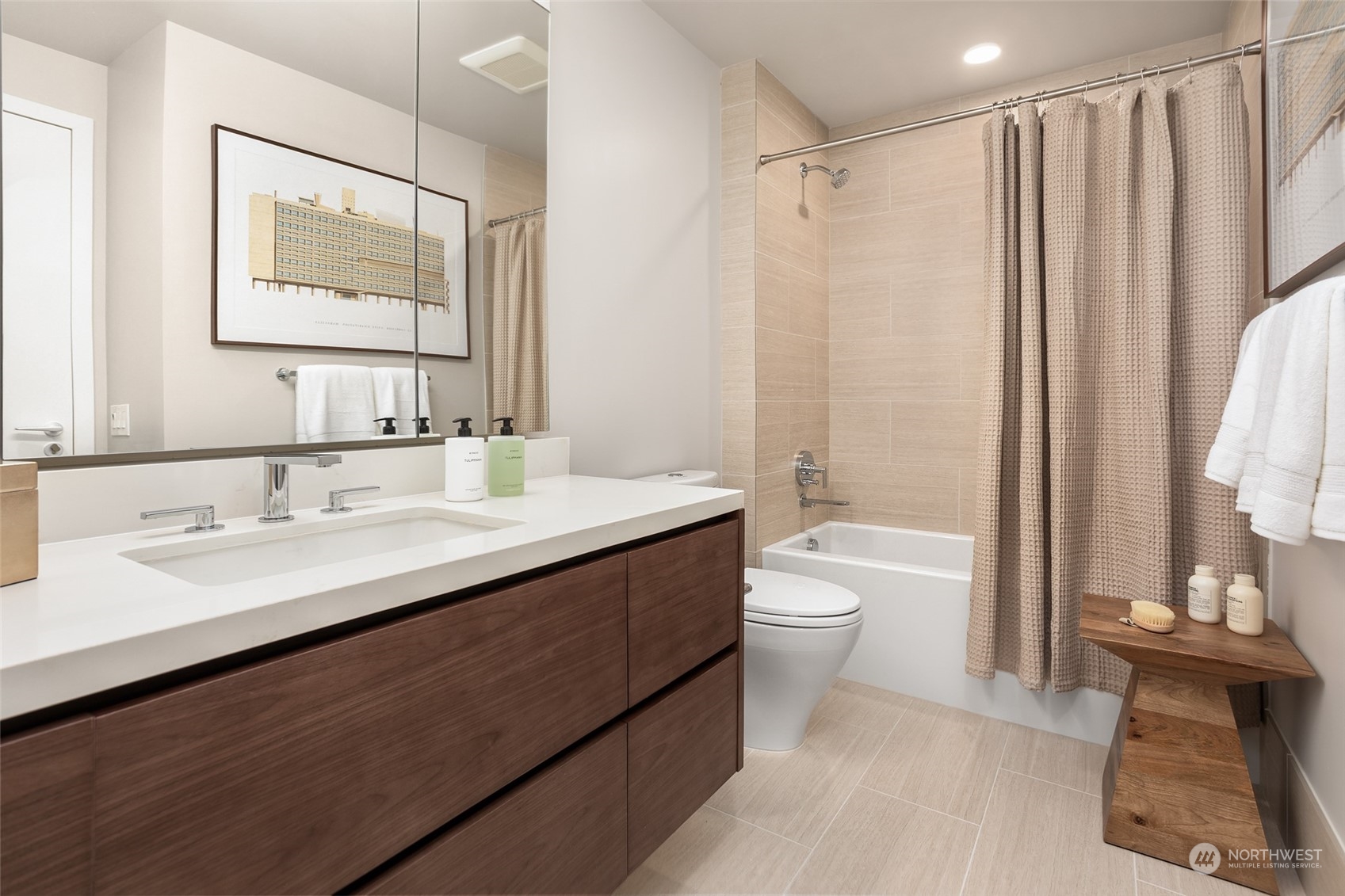 121 Stewart Street, Unit 1701 Seattle, WA 98101 - Photo 15 of 15 a bathroom with a double vanity sink toilet mirror and bathtub
