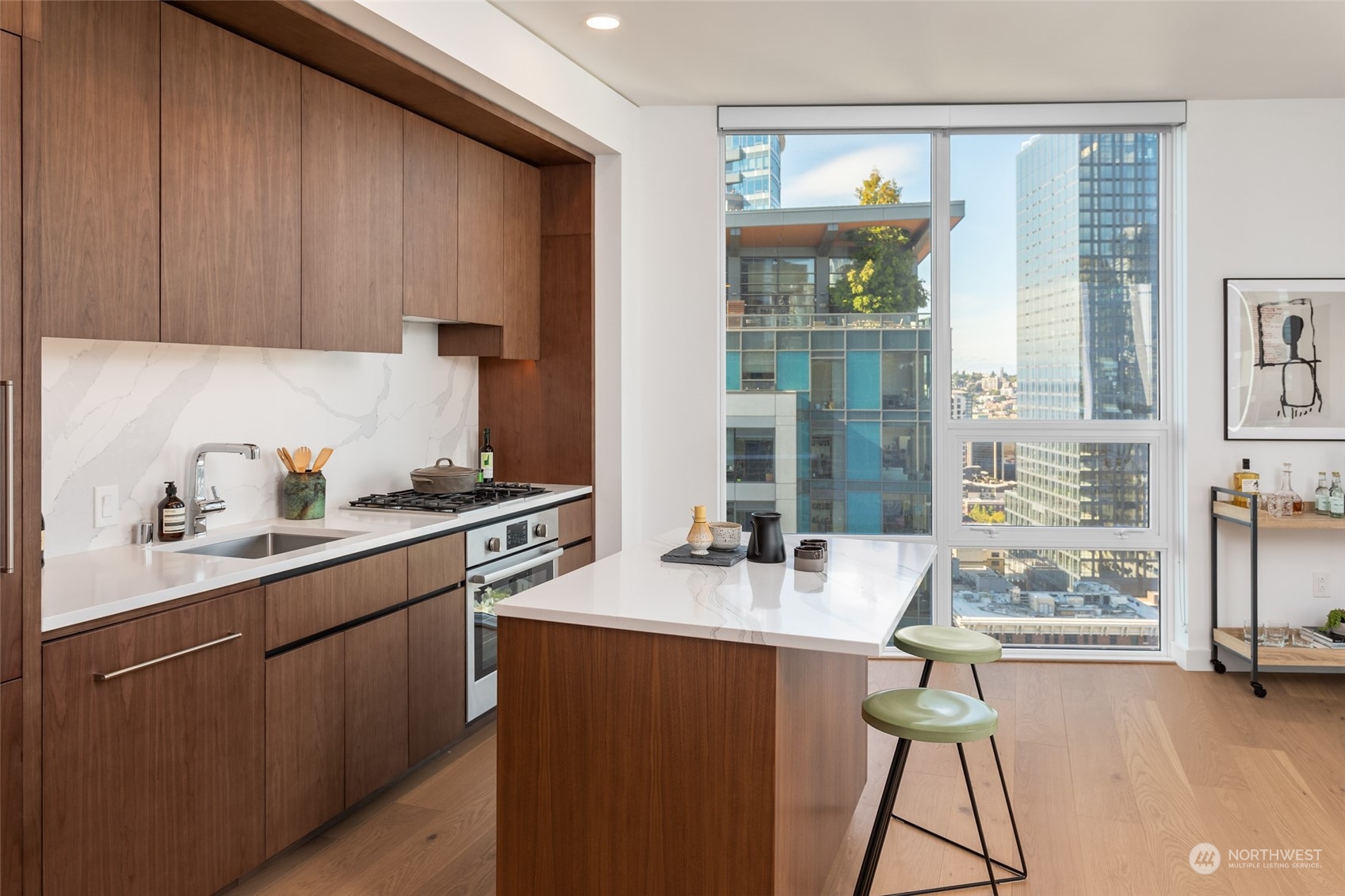 121 Stewart Street, Unit 1701 Seattle, WA 98101 - Photo 3 of 15 a kitchen with a sink cabinets and window