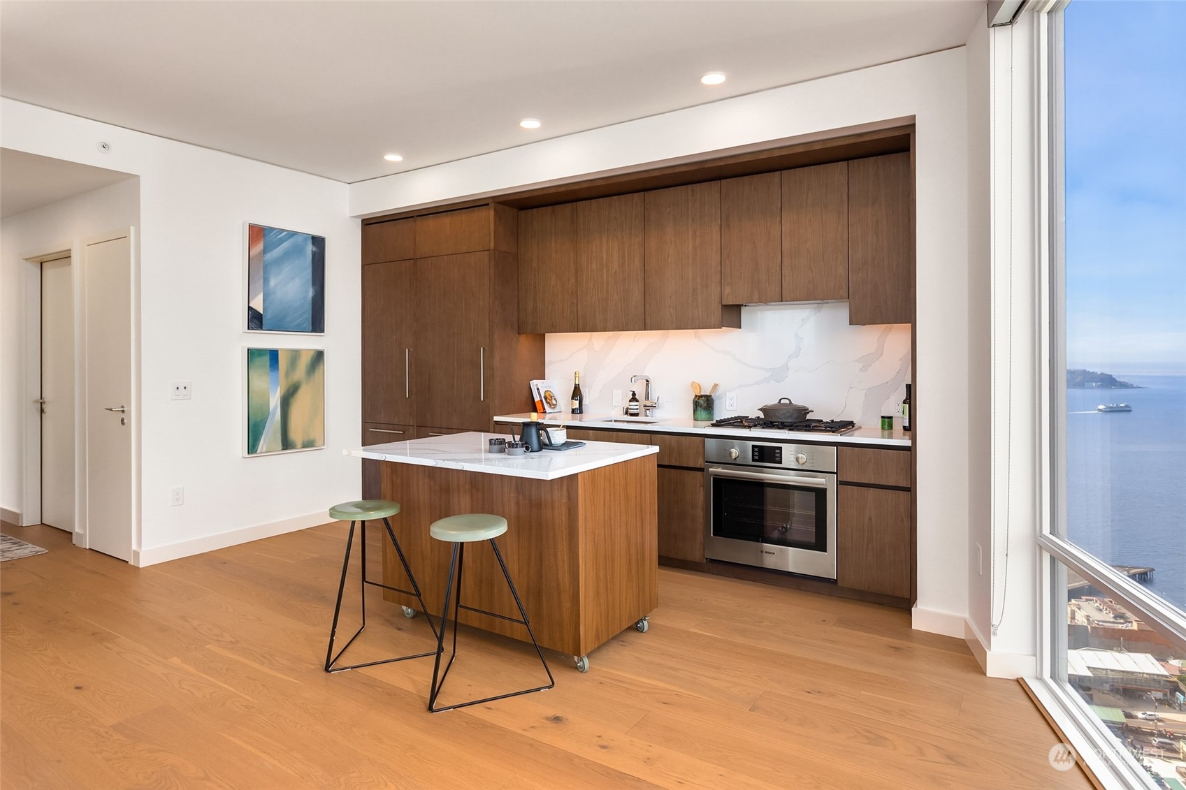 121 Stewart Street, Unit 1701 Seattle, WA 98101 - Photo 4 of 15 a kitchen with a sink cabinets and stainless steel appliances