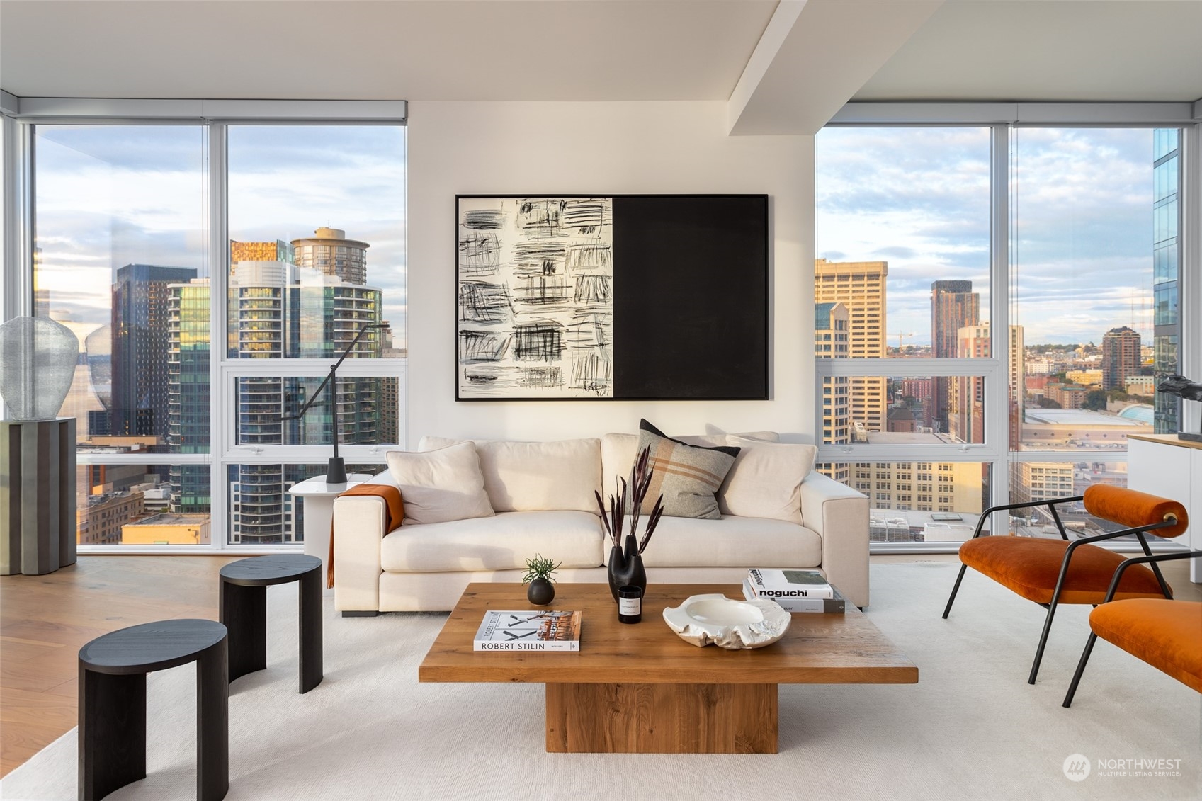 121 Stewart Street, Unit 1701 Seattle, WA 98101 - Photo 5 of 15 a living room with furniture and floor to ceiling windows