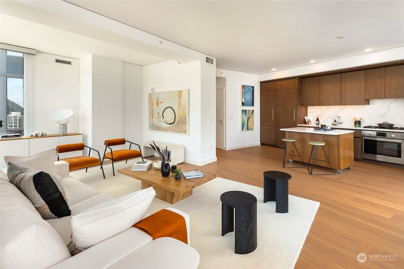 121 Stewart Street, Unit 1701 Seattle, WA 98101 - Photo 7 of 15 a living room with furniture kitchen view and a large window