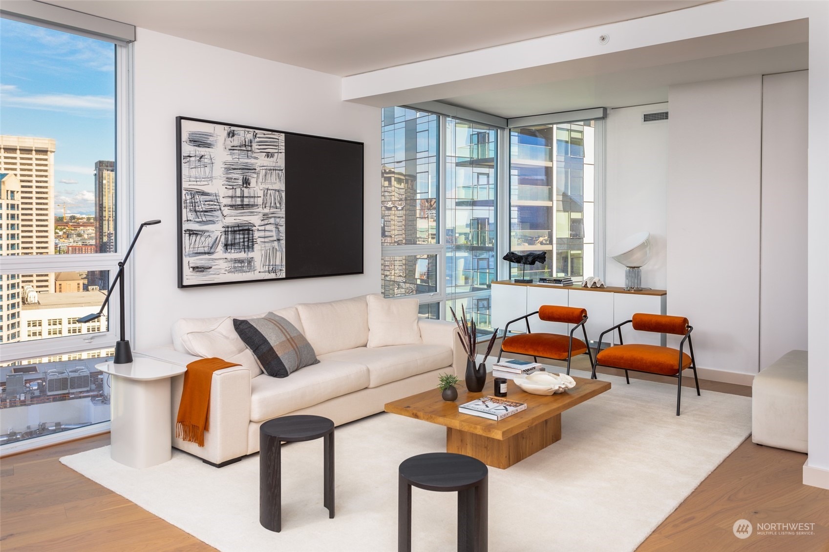 121 Stewart Street, Unit 1701 Seattle, WA 98101 - Photo 8 of 15 a living room with furniture and a large window