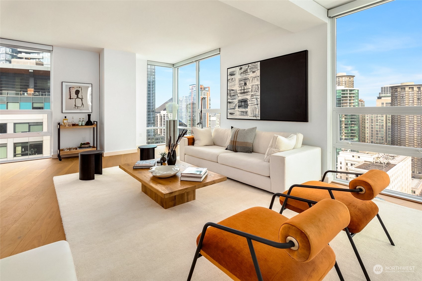 121 Stewart Street, Unit 1701 Seattle, WA 98101 - Photo 9 of 15 a living room with furniture and a flat screen tv