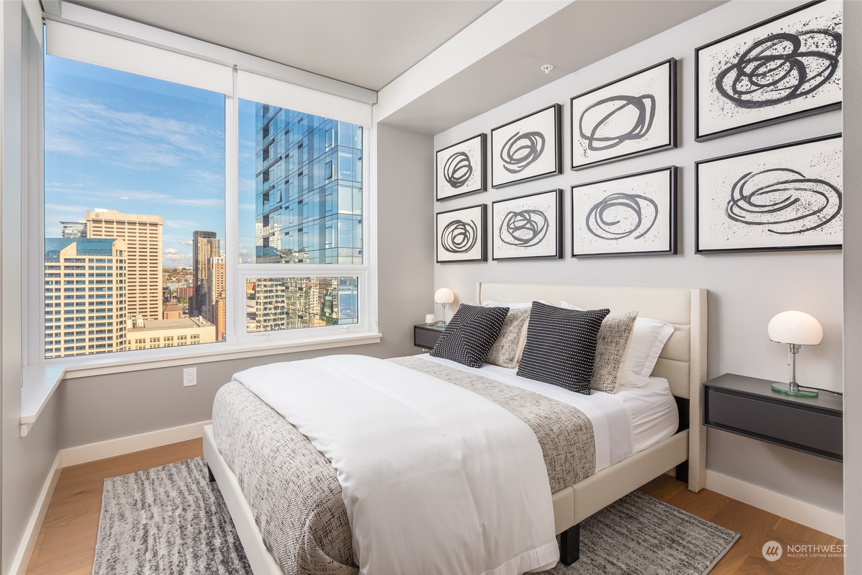 121 Stewart Street, Unit 1701 Seattle, WA 98101 - Photo 10 of 15 a bedroom with a bed and a window
