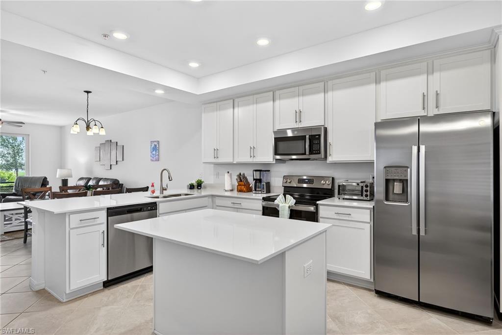 43985 Boardwalk Loop, Unit 2115 Punta Gorda, FL 33982 - Photo 2 of 28 a kitchen with cabinets stainless steel appliances and sink