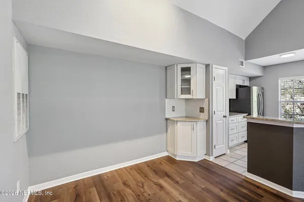 a view of a kitchen with a sink a refrigerator and window