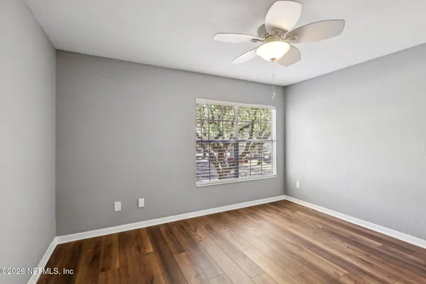 wooden floor in an empty room with a window