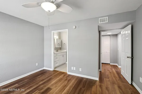 a view of a room with wooden floor