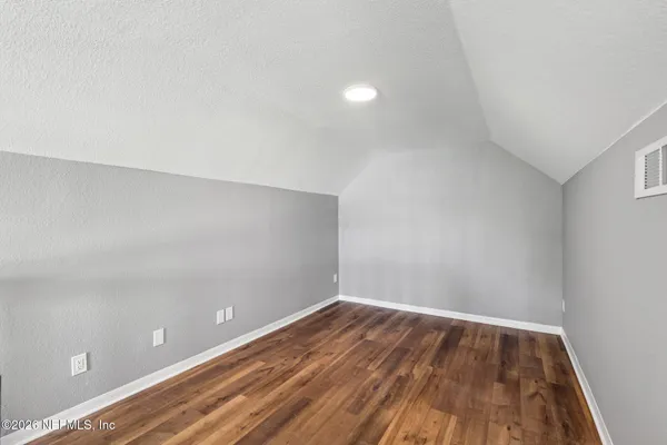 a view of room with wooden floor