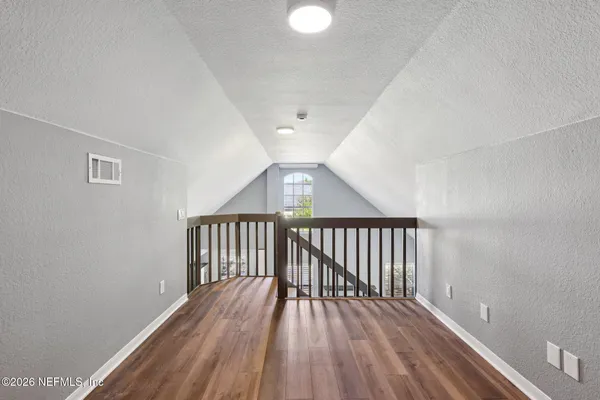 a view of hallway with wooden floor