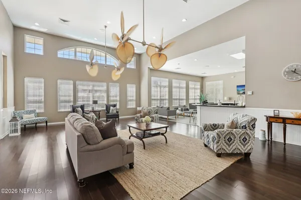 a living room with furniture a couch and a chandelier
