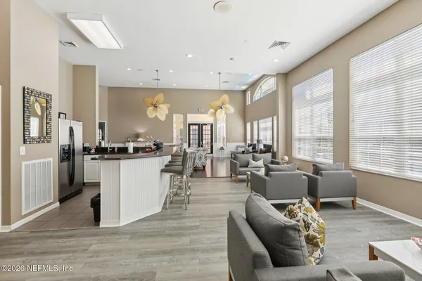 a open kitchen with white cabinets and stainless steel appliances