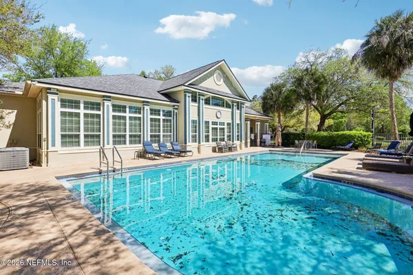 a view of a house with a yard and sitting area