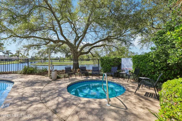 a view of a swimming pool with a patio and a yard