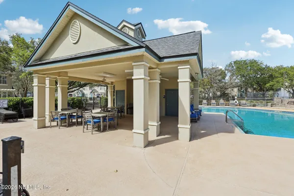 a view of a house with backyard porch and sitting area