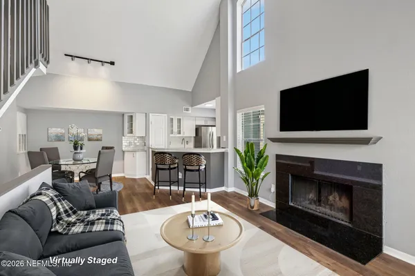 a living room with furniture a fireplace and a flat screen tv