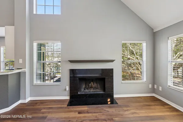 a living room with a fireplace and a window