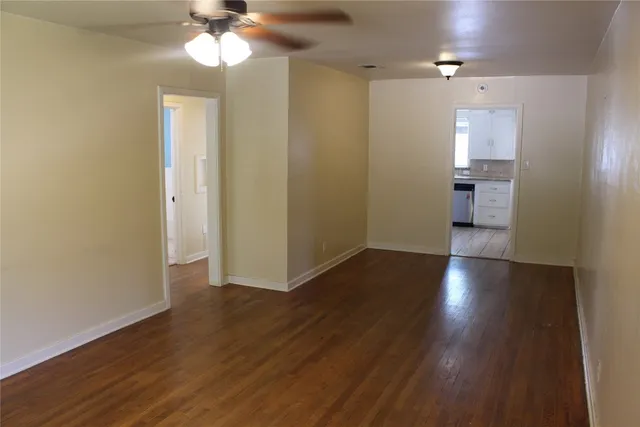 a view of a room with wooden floor and a window