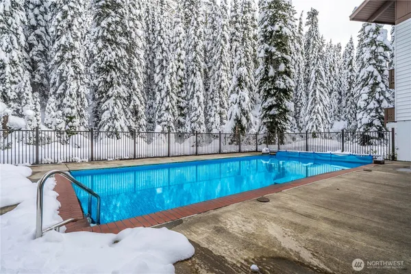 a view of a backyard with wooden fence