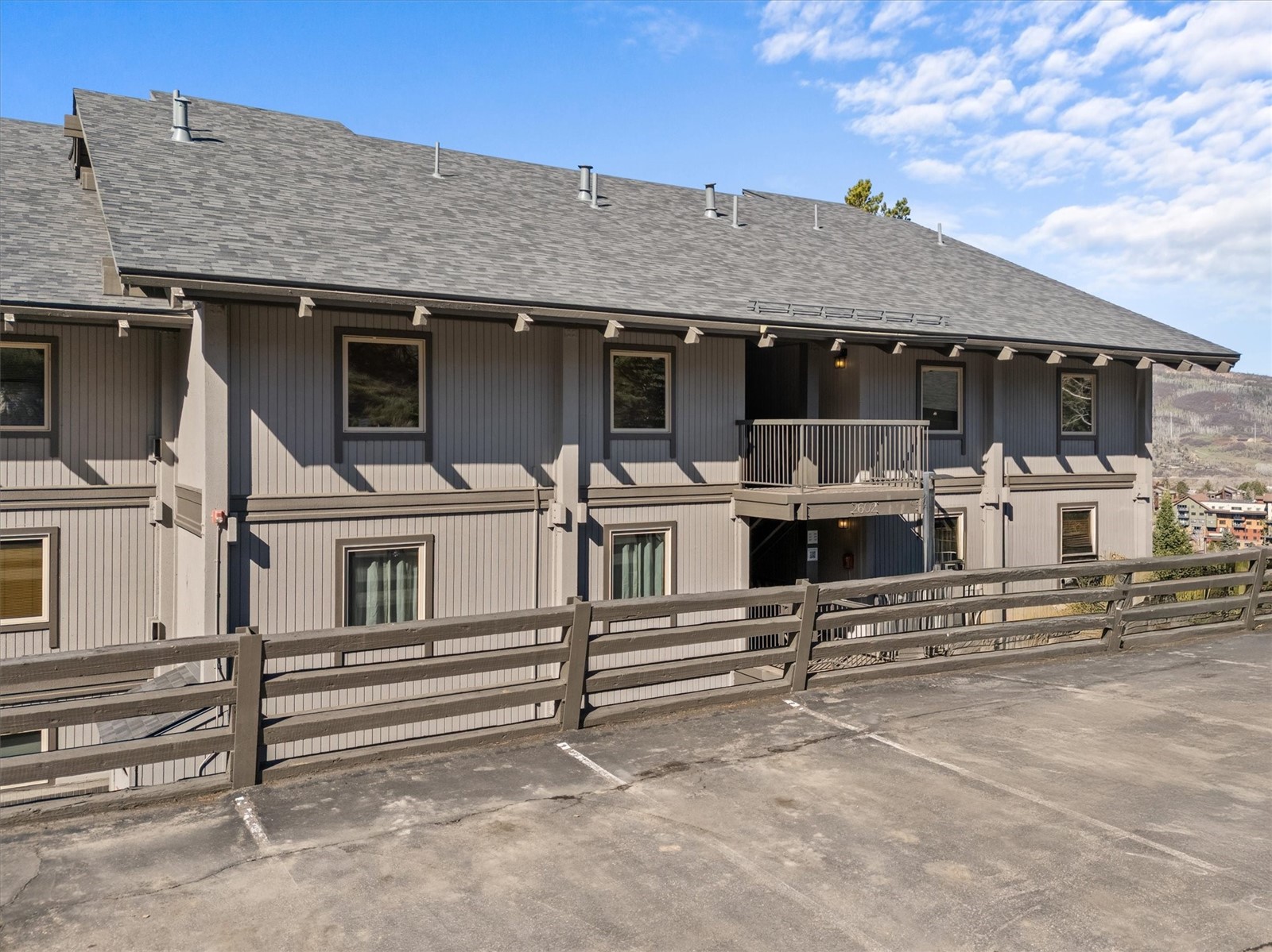 2602 Longthong Road, Unit 107 Steamboat Springs, CO 80487 - Photo 21 of 32 a view of a house with more windows and wooden fence