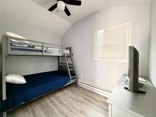 a bedroom with a bunk bed and a desk