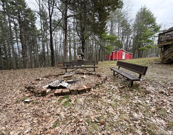 a backyard of a house with table and chairs