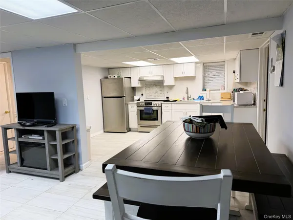 a kitchen with kitchen island a dining table and chairs
