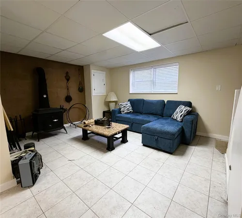 a living room with furniture and a air conditioner vent