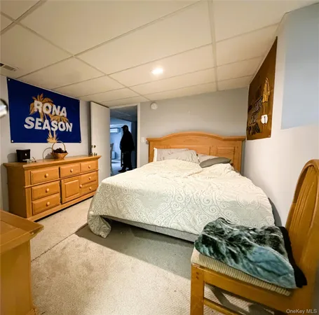 a bedroom with a bed and a night stand