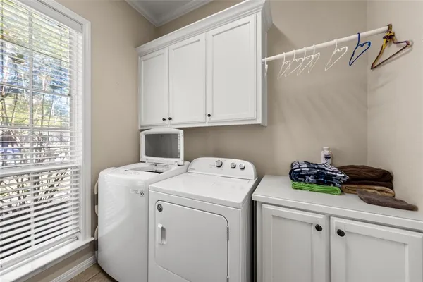 a view of washer and dryer with kitchen view